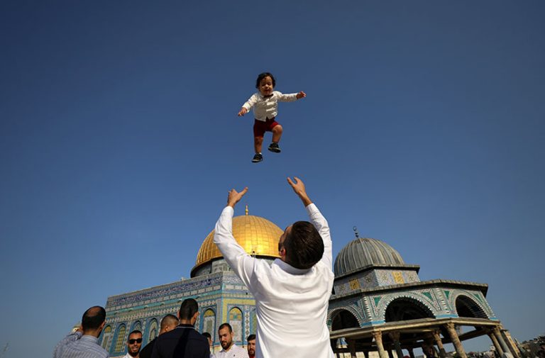 Palestinians celebrate on the first day of Muslim holiday of Eid al-Adha on the compound known to Muslims as Noble Sanctuary and Jews as Temple Mount, in Jerusalem's Old City July 20, 2021. REUTERS/Ammar Awad