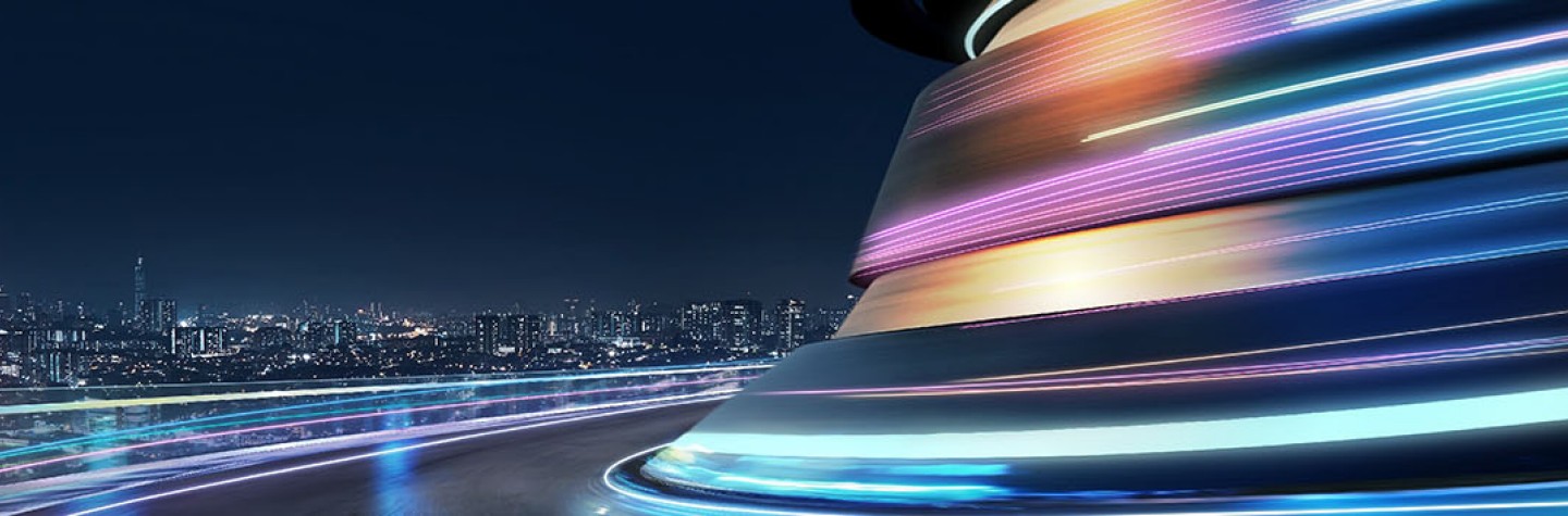 Abstract motion curvy urban road with neon light motion effects with cityscape background at night