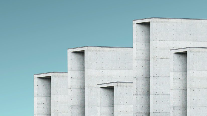 Concrete blocks of varying heights against a blue background