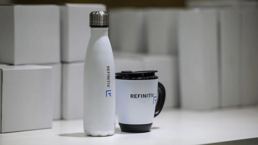 A Refinitiv cup and mug presented with boxes in the background.